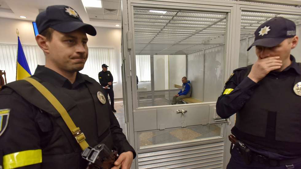 epa09959928 Russian serviceman Vadim Shishimarin (R, back) attends a court hearing in his trial on charges of war crimes, in the Solomyansky district court in Kyiv (Kiev), Ukraine, 20 May 2022. Shishimarin, 21, is accused of killing an unarmed 62-year-old civilian man while fleeing with four other soldiers near Chupakha village in the Sumy area in late February 2022. Ukrainian prosecutors requested a life sentence for Shishimarin, who pleaded guilty to charges. Ukraine is holding the first war crimes trial amid the Russian invasion.  EPA/OLEG PETRASYUK