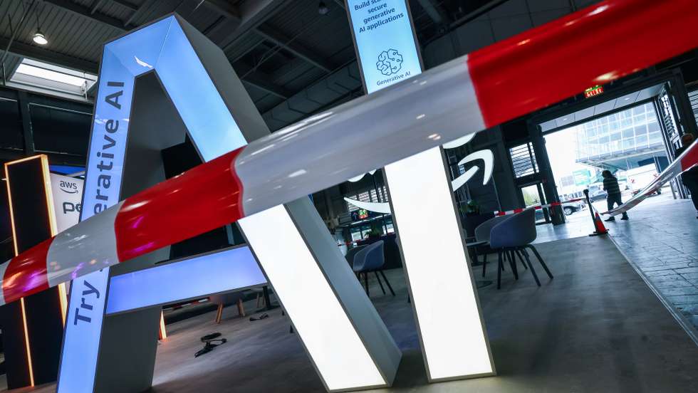 epa11999350 The lettering AI for 'Artificial Intelligence' stands at the Amazon Web Services AWS stand during preparations at the Hanover Fair (Hannover Messe) in Hanover, Germany, 30 March 2025. More than 4,000 exhibitors are expected to showcase their innovations from 31 March to 04 April at what is billed as the world's largest industrial trade fair, with visitors from approximately 150 countries expected. The main focus this year is on robotics, mechanical engineering, power-train technology, and energy production under the motto 'Energizing a Sustainable Industry.' The partner country in 2025 is Canada.  EPA/HANNIBAL HANSCHKE
