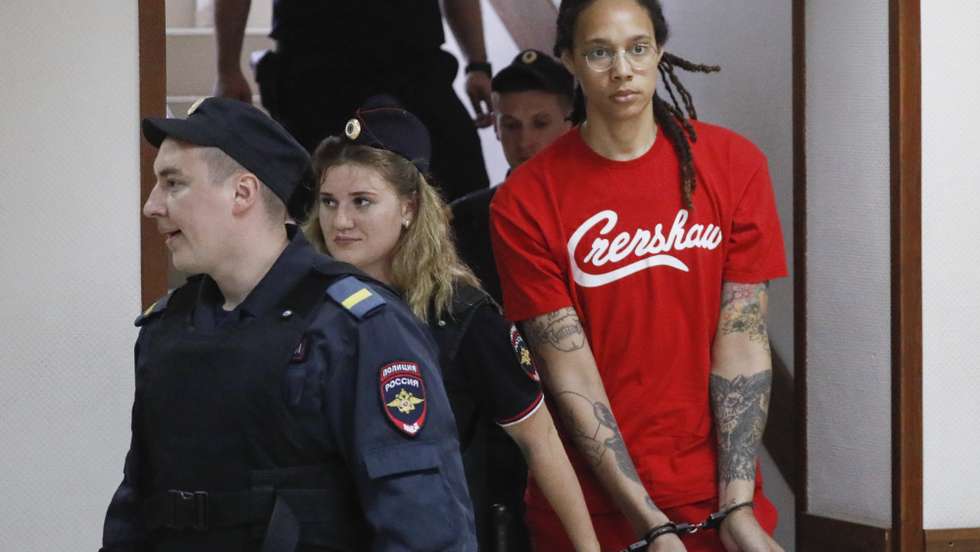epa10056821 Two-time Olympic gold medalist and WNBA's Phoenix Mercury Brittney Griner (R) is escorted to a courtroom for a hearing, in Khimki City Court, outside Moscow, Russia, 07 July 2022. The Khimki City Court reportedly had extended Griner's detention for the duration of her trial on charges of drug smuggling that started on 01 July. Griner was arrested in February at Moscow's Sheremetyevo Airport after some hash oil was detected and found in her luggage, for which she now could face a prison sentence of up to ten years.  EPA/YURI KOCHETKOV