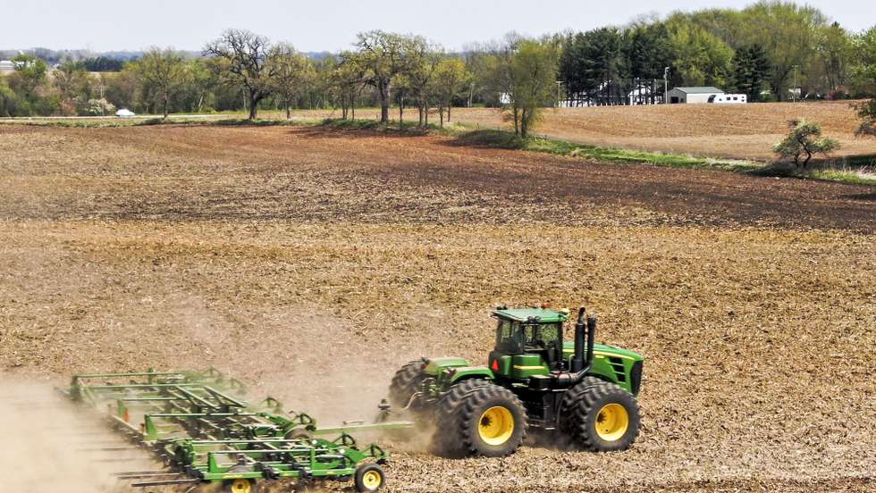 epa09164500 An aerial photo made with a drone shows a farmer preparing a field for spring planting near Prairie Grove, Illinois, USA, 27 April 2021. According to the most recent Purdue University/CME Group Ag Economy Barometer survey of 400 agricultural producers, farmers are seeing good commodity prices and financial conditions of farms leading to a rise in the barometer.  EPA/TANNEN MAURY