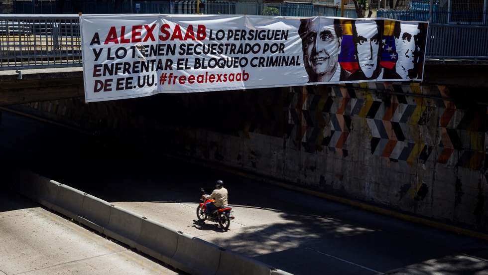 epa09024180 A banner in support of Alex Saab hangs from a bridge in Caracas, Venezuela, 19 February 2021. Venezuelan diplomat Alex Saab was arrested in Cape Verde in June 2020 at the request of the USA for alleged financial crimes, he was later placed under house arrest in January 2021.  EPA/Miguel GutiÃ©rrez