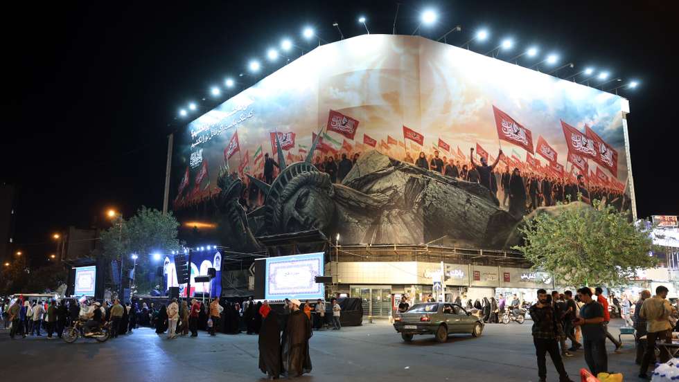 epa13193395 Iranians take part in a night demonstration against the United States near an anti-US billboard in Tehran, Iran, 26 August 2026, following Washington's announcement of new sanctions. Tehran promised to retaliate after US Treasury Secretary Scott Bessent, acting at President Donald Trump's direction, launched 'Operation Economic Outcast,' an economic campaign designed to cut off Iran's global financial connections.  EPA/ABEDIN TAHERKENAREH RESTRICTIONS: NO Access Israel Media/Persian Language TV Stations Outside Iran/Strictly No Access BBC Persian/VOA Persian/Manoto TV/Iran International TV. (As mandated by Iran's Directorate General for Foreign Media) --