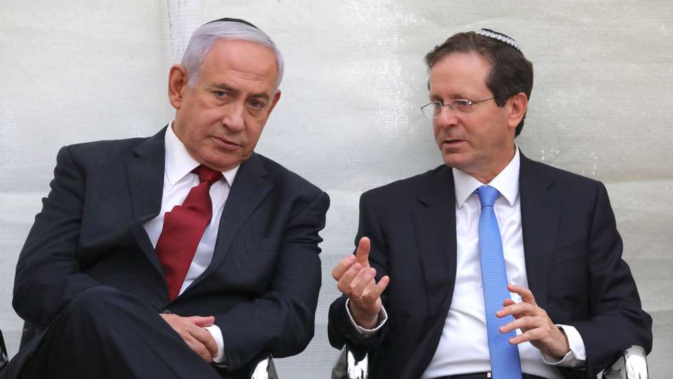 epa09277507 Former Israeli Prime Minister Benjamin Netanyahu (L) and Israeli President elect Isaac Herzog attend a memorial service for Netanyahu's brother fallen Israeli soldier Yoni Netanyahu in mount Herzel in Jerusalem, Israel, 16 June 2021.  EPA/ABIR SULTAN
