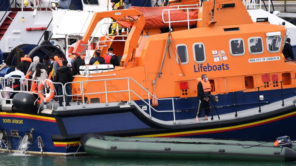 epa08612527 A Royal Lifeboat vessel brings in migrants found off the coast of Dover in Dover, Kent, Britain, 19 August 2020. Britain and France are continuing ongoing talks to try to resolve the migrant crisis in the English Channel. Migrants from Syria and other countries are continuing to arrive along the coast of the UK in their quest for asylum.  EPA/ANDY RAIN