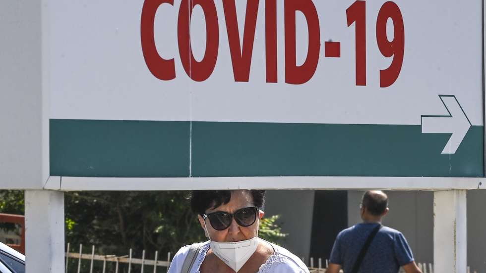epa09417747 A woman wearing protective mask, walks in front of the University Clinic for Infectious Diseases in Skopje, North Macedonia, 17 August 2021. The number of new coronavirus cases has grow at an alarming rate in North Macedonia over the past two weeks.The situation with the COVID-19 has drastically worsened. Capacities of infectious diseases clinics have been filled. North Macedonia’s Government start with implementation of anti-COVID-19 measures for those who did not get a vaccine. Citizens who have not received the vaccine against COVID-19 cannot enter cafeterias, restaurants and all public enclosed spaces. The penalty for non-compliance with the new measures is up to 30,000 euros from the owner of the facility.  EPA/GEORGI LICOVSKI