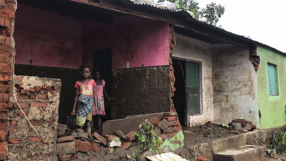 epa09711843 Children stand at their destroyed house after Tropical Storm Ana hit the district of Tete, Mozambique, 27 January 2022. The number of deaths caused by Tropical Storm Ana in Mozambique has risen to 20 people according to data from local authorities and civil protection, and the population lives in a trail of destruction. The storm hit the country directly between Monday and Wednesday, but despite having already weakened and moved on to other countries (Zimbabwe and Zambia), the heavy rains have fed the flow of all rivers in central and northern Mozambique, which continue to cause flooding.  EPA/ANDRE CATUEIRA