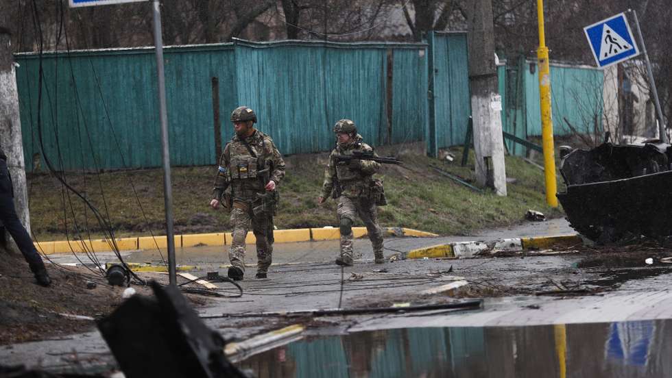 epa09868088 Ukrainian soldiers pass by a destroyed Russian military machinery in the areas recaptured by the Ukrainian army in the city of Bucha, Ukraine, 03 April 2022. Dmitrivka and the area around had recently been recaptured by the Ukrainian army from Russian forces. On 24 February, Russian troops had entered Ukrainian territory in what the Russian president declared a 'special military operation', resulting in fighting and destruction in the country, a huge flow of refugees, and multiple sanctions against Russia  EPA/ATEF SAFADI