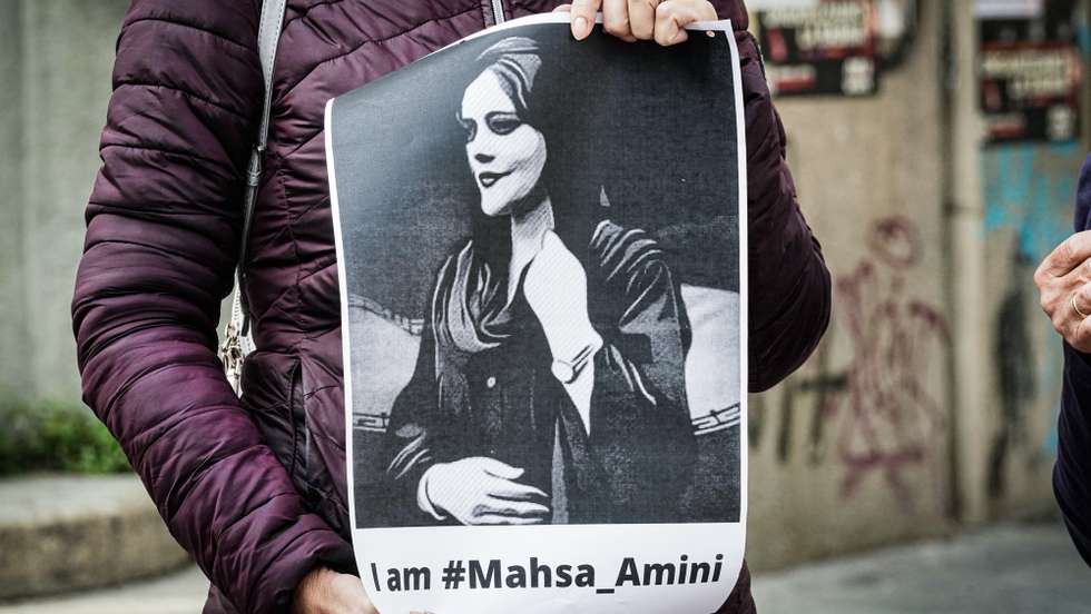 epa10240460 A participant holds a placard in protest following the death of Iranian Mahsa Amini, during the event 'We reveal freedom' with veiling and unveiling of the statue Echo in support of freedom of Iranians, organized by 'Associazione radical Aglietta and +Europa', in Turin, Italy, 13 October 2022. Amini, a 22-year-old Iranian woman, was arrested in Tehran on 13 September by the police unit responsible for enforcing Iran's strict dress code for women. She fell into a coma while in police custody and was declared dead on 16 September.  EPA/TINO ROMANO
