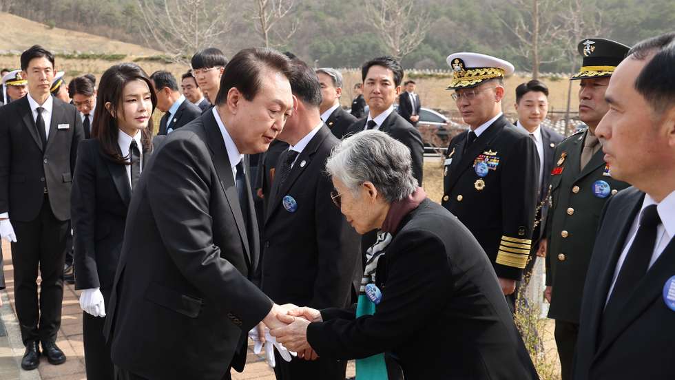 epa10539827 South Korean President Yoon Suk Yeol (C-L) greets bereaved family members of the victims of inter-Korean naval clashes during a ceremony at a national cemetery in Daejeon, South Korea, 24 March 2023. The ceremony marks the eighth anniversary of the commemoration day for 55 troops who died in three major clashes with North Korea in the West Sea, comprising an inter-Korean naval skirmish in 2002, North Korea's torpedo attack on the corvette Cheonan in 2010 and its shelling of the border island of Yeonpyeong in the same year. Since 2016, the government has designated the fourth Friday of March as a commemoration day, known as West Sea Defense Day.  EPA/YONHAP SOUTH KOREA OUT