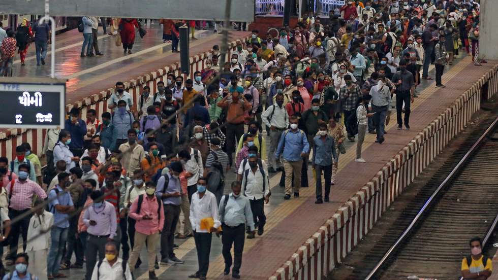epa09108475 Indian people wearing face masks to avoid the spread of coronavirus COVID19 disease wait on the platform to board the local train at the Chhatrapati Shivaji Maharaj Terminus railway station, in Mumbai, India, 31 March 2021. Due to the massive Covid-19 spike, Maharashtra government put restrictions on public gatherings and imposed night curfew from 8pm to 7am, in which public places including parks, beaches, shopping malls, hotels, and pubs will remain shut.  EPA/DIVYAKANT SOLANKI