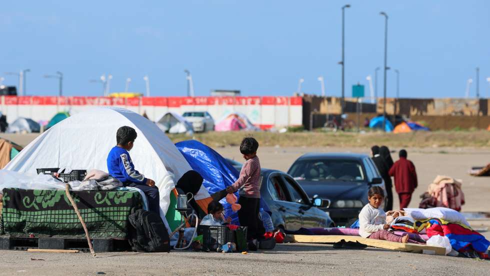epa12825460 Internally displaced residents with belongings sit next to tents fleeing their homes in southern Lebanon and the southern suburbs of Beirut following Israeli airstrikes in Beirut, Lebanon, 16 March 2026. Lebanese authorities report more than 831,000 registered displaced since the escalation began on 02 March 2026, though the true number is likely higher, as many stay with relatives or seek shelter in safer areas.  EPA/WAEL HAMZEH