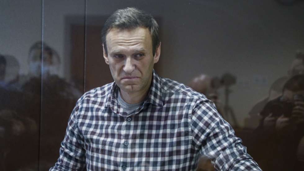 epa09025232 Russian opposition leader Alexei Navalny stands inside a glass cage prior to a hearing at the Babushkinsky District Court in Moscow, Russia, 20 February 2021. The Moscow City court will hold a visiting session at the Babushkinsky District Court Building to consider Navalny's lawyers appeal against a court verdict issued on 02 February 2021, to replace the suspended sentence issued to Navalny in the Yves Rocher embezzlement case with an actual term in a penal colony.  EPA/YURI KOCHETKOV MANDATORY CREDIT