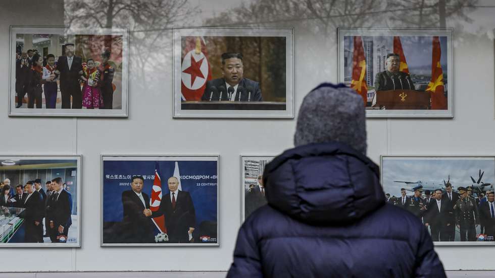 epa11691980 A person looks at photos of North Korean Leader Kim Jong Un, outside of the Embassy of the Democratic People's Republic of Korea (DPRK) in Moscow, Russia, 30 October 2024. North Korean state news agency KCNA and Russian officials on 30 October confirmed that North Korean Foreign Minister Choe Son Hu was traveling to Moscow after arriving in Vladivostok the previous day. Choe's visit comes after NATO joined Seoul, Washington and Kyiv in confirming Pyongyang's deployment of troops to Russia's Kursk region on the border with Ukraine.  EPA/YURI KOCHETKOV