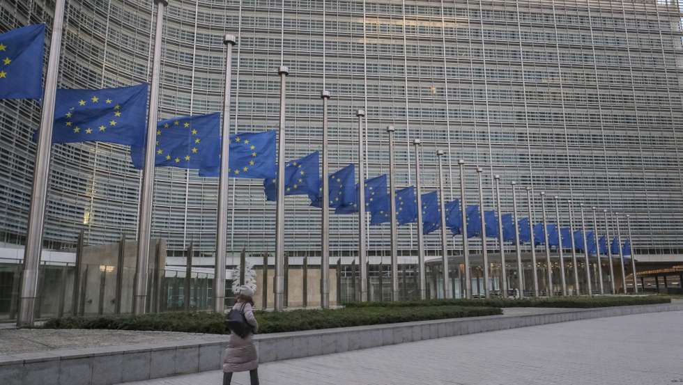 epa09678430 European flags are lowered to half mast in front of the seat of the European Commission in commemoration of late European Parliament President David Sassoli, at EU headquarters in Brussels, Belgium, 11 January 2022. David Sassoli, the Italian journalist who worked his way up in politics and became president of the European Union's parliament, died at a hospital in Italy early 11 January 2022, his spokesperson said.  EPA/OLIVIER HOSLET