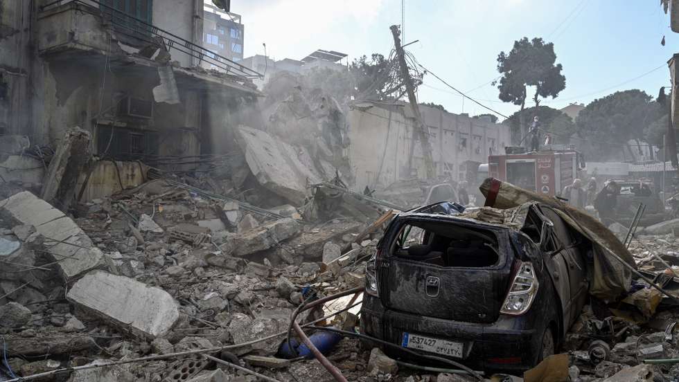 epaselect epa11718318 Damaged cars outside a destroyed building at the site of an Israeli airstrike in the Al-Chiyah area in southern Beirut, Lebanon, 13 November 2024. According to the Lebanese Ministry of Health, around 3,300 people have been killed and over 14,200 others have been injured in Lebanon since the escalation in hostilities between Israel and Hezbollah.  EPA/WAEL HAMZEH