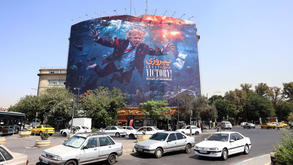 epa13188122 Iranians drive past an anti-US billboard featuring US President Donald Trump in southern Tehran, Iran, 24 August 2026. US President Donald Trump said the US will launch 'economic D-Day' sanctions against Iran as the conflict between Iran and the US continues.  EPA/ABEDIN TAHERKENAREH RESTRICTIONS: NO Access Israel Media/Persian Language TV Stations Outside Iran/Strictly No Access BBC Persian/VOA Persian/Manoto TV/Iran International TV. (As mandated by Iran's Directorate General for Foreign Media) --