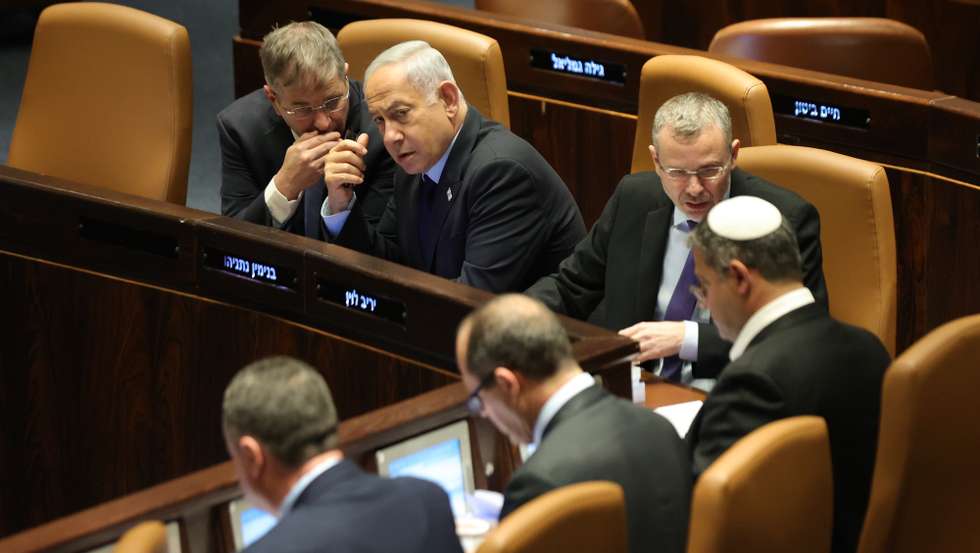epa10536863 Israeli Prime Minister Benjamin Netanyahu (2-L) attends a voting session on judicial reform bill at the Knesset Plenum, in Jerusalem, Israel, 22 March 2023. Nationwide protests against the government's judicial reform plans are being held for 12 weeks in a row. Israel's parliament passed a draft law limiting the power of the Israeli Supreme Court in a first reading on 14 March.  EPA/ABIR SULTAN