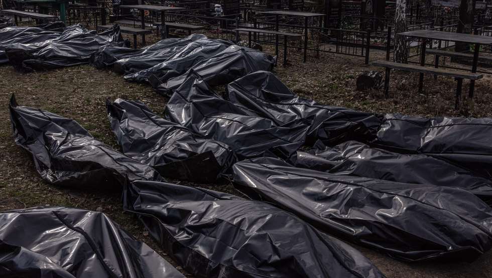 epaselect epa09877034 Bodies of killed people, which were brought to the cemetery, lay on the ground in body bags, in Bucha, northwest of Kyiv, Ukraine, 07 April 2022. Hundreds of tortured and killed civilians have been found in Bucha and other parts of the Kyiv region after the Russian army retreated from those areas. The growing evidence shows that the Russian forces are believed to be behind the atrocities when they were controlling the areas. Russian troops entered Ukraine on 24 February resulting in fighting and destruction in the country and triggering a series of severe economic sanctions on Russia by Western countries.  EPA/ROMAN PILIPEY
