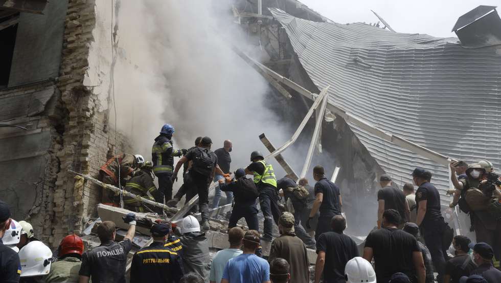 epa11466643 Rescue workers at the site of a rocket strike on the 'Okhmadyt' children's hospital in Kyiv, Ukraine, 08 July 2024 amid the undoing Russian invasion. Russia massively attacked Ukraine with missiles 08 July, striking Kyiv, Dnipro, Kryvyi Rih, Sloviansk and Kramatorsk. More than 40 missiles of different types were launched, striking residential buildings, infrastructure and the children's hospital. At least seven people were killed and 25 injured as result of shelling in Kyiv according to the State Emergency Service report.  EPA/SERGEY DOLZHENKO