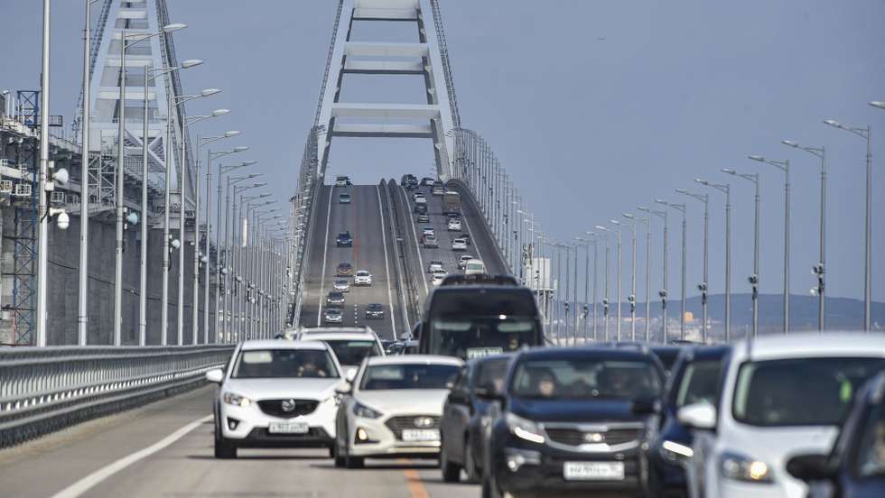 epa10485423 Cars drive across the Crimean bridge in Crimea, 23 February 2023. Automobile traffic resumed on all lanes of the Crimean bridge on 23 February, 39 days ahead of schedule, the press service of Russia's Deputy Prime Minister Marat Khusnullin announced. The motorway of the Crimean Bridge was damaged by an explosion last October. To restore the bridge, some 2,442 tons of metal structures were manufactured, which were delivered from Tyumen, Voronezh and Kurgan. The builders needed to replace four spans on both sides of the bridge, lay two layers of asphalt concrete pavement and install lighting masts.  EPA/STRINGER