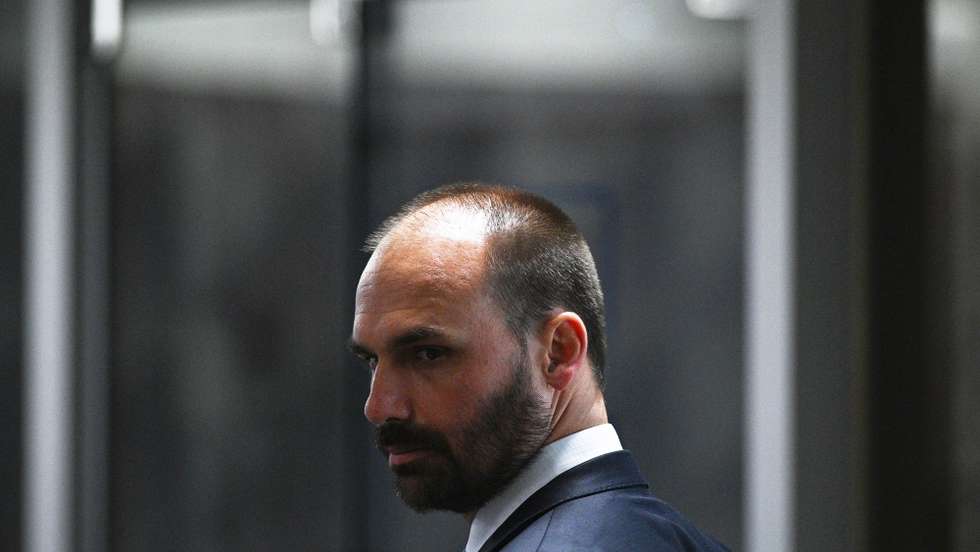 epa10804845 Deputy Eduardo Bolsonaro, son of former Brazilian president Jair Bolsonaro, participates in the statement session of computer expert Walter Delgatti before the Mixed Parliamentary Commission of Investigation (CPMI) on the anti-democratic acts of 08 January 2023 against the Federal Senate, in Brasilia, Brazil, 17 August 2023. Walter Delgatti who worked for a far-right deputy confessed that former Brazilian president Jair Bolsonaro (2019-2022) suggested he invade the National Council of Justice systems in order to demonstrate the supposed fragility of the voting system for the elections of the year past. Delgatti said the far-right ex-president even promised him 'a pardon' in case he was found out.  EPA/Andre Borges