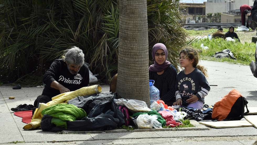 epa12794509 Displaced residents sit on the sidewalk in Beirut, Lebanon, on 04 March 2026, after fleeing their homes in south Lebanon and the southern suburbs of Beirut following Israeli strikes. The Israeli military stated it is conducting strikes across the country targeting Hezbollah infrastructure and personnel. According to the Lebanese Ministry of Public Health, at least 50 people were killed and 335 others injured in airstrikes across Beirut's southern suburbs and villages in southern Lebanon.  EPA/WAEL HAMZEH