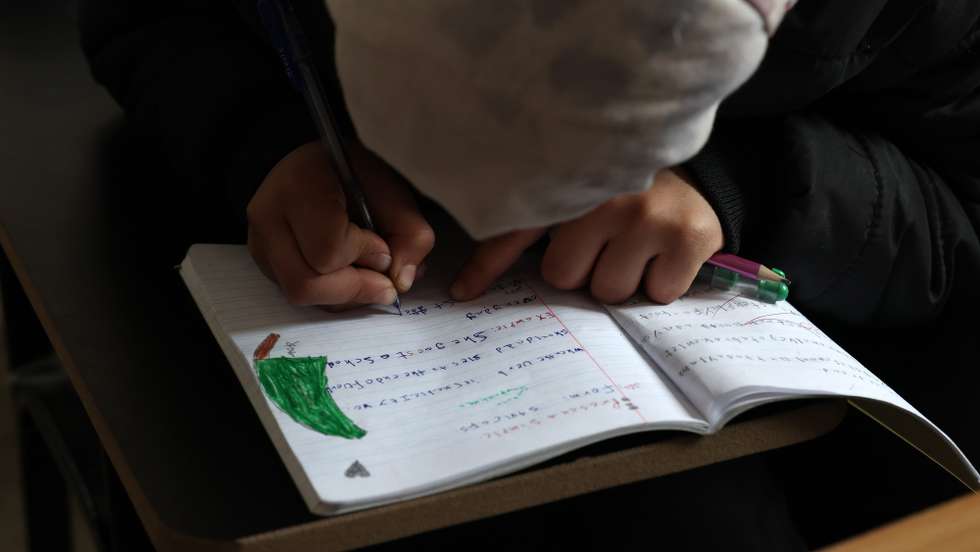 epa12636553 A refugee child attends her school class in a makeshift shelter at the Imam Ali Complex in Hermel, Bekaa Valley, near the border with Syria, northeastern Lebanon, 08 January 2026. The housing project, inaugurated on 11 December 2025, is a donation from Iran and was carried out under the supervision of Iranian engineers. It consists of 228 residential units housing at least 900 refugees, most of whom are Lebanese and Syrians from villages along the border who fled following the fall of the Syrian regime of ousted president Bashar al-Assad.  EPA/WAEL HAMZEH