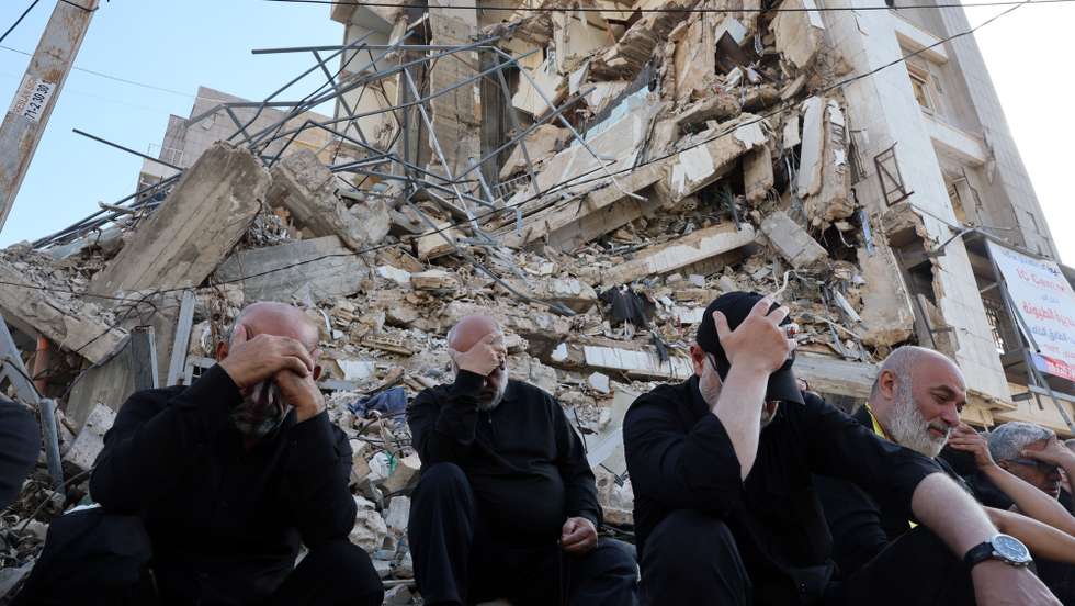 epa13066093 Hezbollah supporters mourn as they listen to the story of Imam Hussain while taking part in an Ashura Day procession, in front of a destroyed building in southern Beirut, Lebanon, 26 June 2026. Shia Muslims worldwide observe the holy month of Muharram, the first month of the Islamic calendar, which culminates with the commemoration of Ashura on its tenth day, of the martyrdom of Imam Hussain, grandson of the Prophet Muhammad, who was killed at the Battle of Karbala.  EPA/WAEL HAMZEH