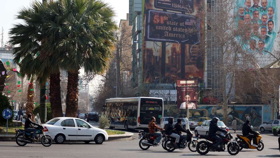 epa12775554 Iranians drive past a new anti-Israeli and US billboard carrying a sentence in Persian reading, 'The next target is clear, Trump's 51-state Israel,' at Palestine Square in Tehran, Iran, 25 February 2026. As Iran and the US are set to hold another round of talks in Geneva on 26 February, US President Donald Trump said the US will not allow Iran to have nuclear weapons.  EPA/ABEDIN TAHERKENAREH