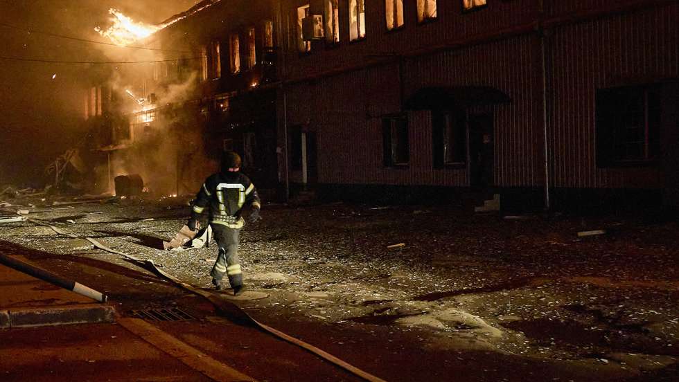 epa11857519 Ukrainian rescuers work at the site of a drone strike on a private factory in Kharkiv, northeastern Ukraine, 28 January 2025, amid the Russian invasion. A fire broke out in a private factory in Kharkiv after being hit by a Russian unmanned aerial vehicle overnight, covering an area of about 1,500 square meters. No casualties were reported in the attack, according to the State Emergency Service of Ukraine (SESU).  EPA/SERGEY KOZLOV