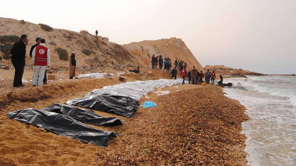 epa05806588 A handout photo made available by the Libyan Red Crescent shows volunteers of the Red Crescent recovering bodies washed ashore at the coast near Al Zawiya, Libya, 20 February 2017 (issued 21 February 2017). According to the Red Crescent, at least 74 bodies of suspected refugees trying to cross the Mediterranean Sea have been recovered by volunteers on 20 February.  EPA/LIBYAN RED CRESCENT HANDOUT BEST QUALITY AVAILABLE. HANDOUT EDITORIAL USE ONLY/NO SALES