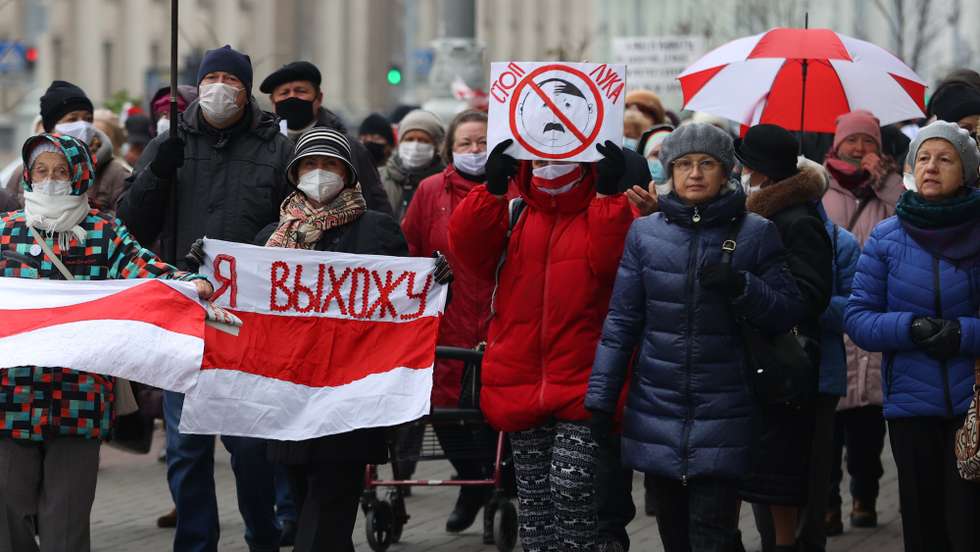 epa08823719 Belarusian pensioners with flag reading 'I'm going out' and a poster 'Stop Luka' march during a rally to protest against the government and Belarusian President Lukashenko in Minsk, Belarus, 16 November 2020. Belarusian people protest since presidential elections on 09 August, against government and demanding the resignation of President Lukashenka and new fair elections.  EPA/STR