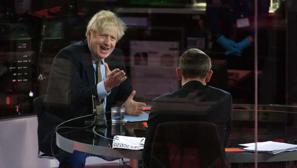 epa08916421 A handout photo made available by the British Broadcasting Corporation (BBC) shows Britain's Prime Minister Boris Johnson appearing at the Andrew Marr show in the BBC studios in London, Britain, 03 January 2021. Johnson said during the interview that Boris Johnson told the BBC that Britain may be facing tougher measures in weeks ahead as the nation battles the ongoing COVID-19 coronavirus pandemic.  EPA/JEFF OVERS HANDOUT ATTENTION EDITORS: PICTURE TAKEN THROUGH GLASS HANDOUT EDITORIAL USE ONLY/NO SALES
