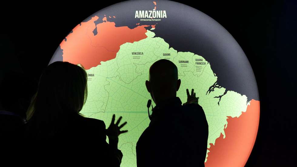 epa09646878 Visitors enjoy a tour prior to the opening of the exhibition 'Fruturos - Tempos Amazonicos' (Fruits - Amazon Times) at the Amanha Museum in Rio de Janeiro, Brazil, 16 December 2021 (issued 17 December 2021). The immensity of the Amazon, its richness, the ethnic groups that live there and their customs, are part of an exhibition in Rio de Janeiro that from 17 December on immerses the viewer in the reality of the most extensive tropical forest on the planet to highlight the urgency of its conservation. The exhibition 'Futures', which can be seen until June 2022 at the Museum of Tomorrow in Rio, brings an updated perspective of this biome and proposes new challenges to keep the forest standing.  EPA/Andre Coelho