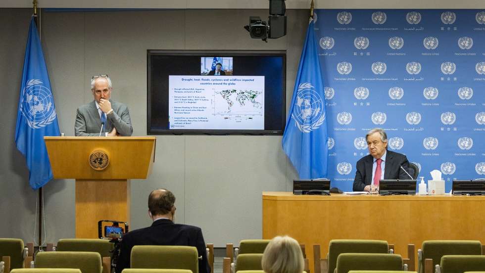 epa09145839 United Nations Secretary-General Antonio Guterres (R) and Stephane Dujarric (L), the Spokesperson for the Secretary-General, listen to a presentation by Professor Petteri Taalas, on screen, the Secretary-General of the World Meteorological Organization, about the report ‘State of the Global Climate in 2020’ during a partially virtual press conference at United Nations headquarters in New York, New York, USA, 19 April 2021. The report details a number of facts about the global climate including that 2020 was one of the hottest years on record and that the temporary decrease in carbon emissions as a result of the coronavirus pandemic had minimal affect on the concentration of greenhouse gases in the atmosphere.  EPA/JUSTIN LANE