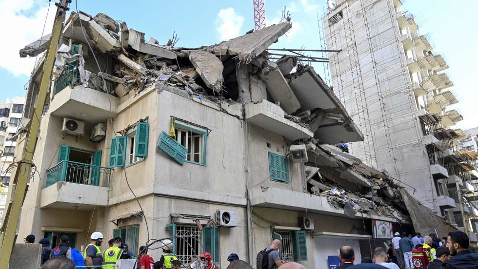 epa11725724 Rescue workers and people gather at the site of an Israeli airstrike which targeted the Baath party headquarters in Ras Al Naba'a neighborhood of Beirut, Lebanon 17 November 2024. According to the Lebanese Ministry of Health, one person was killed and three others injured in the airstrike. According to the Lebanese Ministry of Health, more than 3,450 people have been killed and over 14,650 others have been injured in Lebanon since the escalation in hostilities between Israel and Hezbollah.  EPA/WAEL HAMZEH