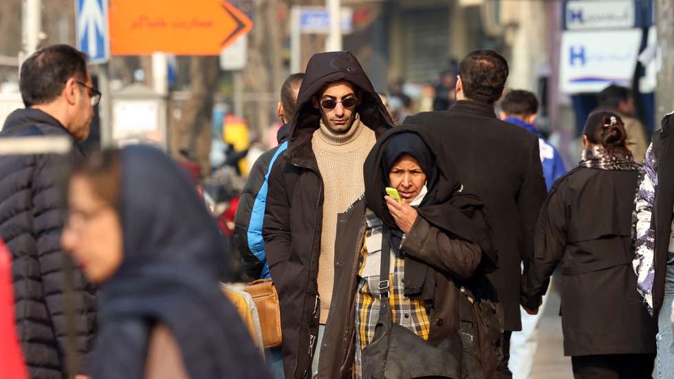 epa12635824 Iranians walk on a street in Tehran, Iran, 08 January 2026. Following a sharp decline in the national currency and soaring prices for basic goods, the country is facing a wave of nationwide anti-government protests which has spread to 37 cities across 24 provinces, according to the Human Rights Activists News Agency (HRANA).  EPA/ABEDIN TAHERKENAREH
