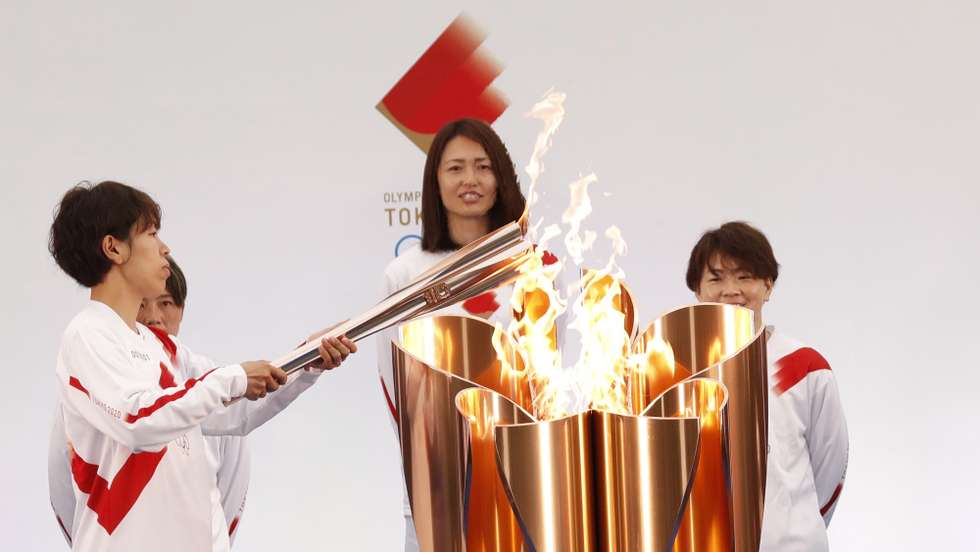 epa09095217 The Olympic torch is lit by a member of Japan's women's national soccer team Nadeshiko Japan during the Tokyo 2020 Olympic Torch Relay Grand Start in Naraha, Fukushima prefecture, Japan, 25 March 2021. The postponed Tokyo 2020 Olympic Games are scheduled to start on 23 July 2021 and some 10,000 torchbearers will run across the country along a 121-day journey.  EPA/KIM KYUNG-HOON / POOL
