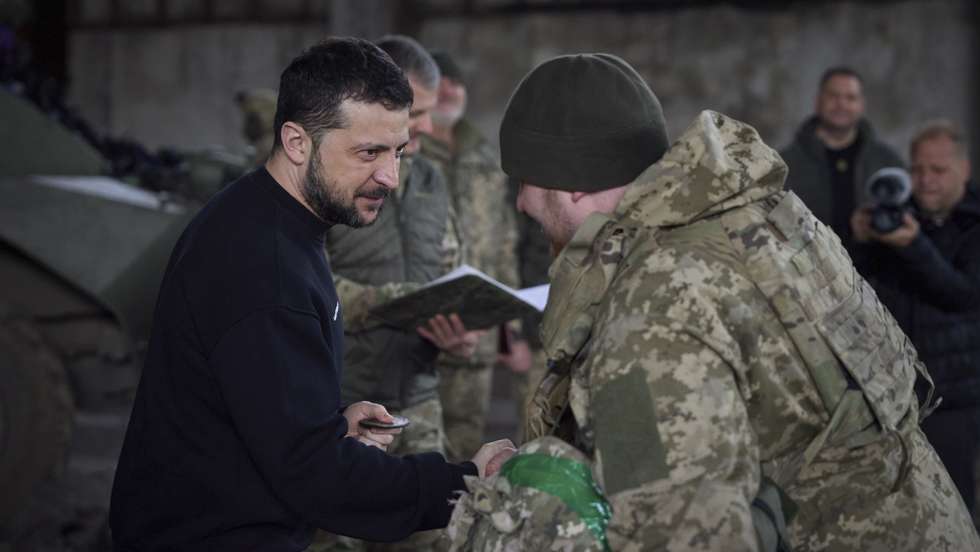 epa10536773 A handout photo made available by the Ukrainian Presidential Press Service shows Ukrainian President Volodymyr Zelensky (L) awarding a serviceman as he visits the advanced positions of the Ukrainian military in the Bakhmut direction, during a working trip to the Donetsk region, at an undisclosed location in Ukraine, 22 March 2023, amid the Russian invasion of the country. Russian troops entered Ukrainian territory on 24 February 2022, starting a conflict that has provoked destruction and a humanitarian crisis.  EPA/PRESIDENTIAL PRESS SERVICE HANDOUT  HANDOUT EDITORIAL USE ONLY/NO SALES