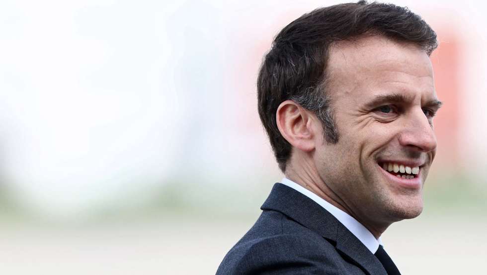 epa10534820 French President Emmanuel Macron reacts as freed French journalist Olivier Dubois, who was held hostage in Mali for nearly two years, is welcomed by family members upon his arrival at the Villacoublay airport, in Velizy-Villacoublay, near Paris, France, 21 March 2023.  EPA/YVES HERMAN/POOL MAXPPP OUT