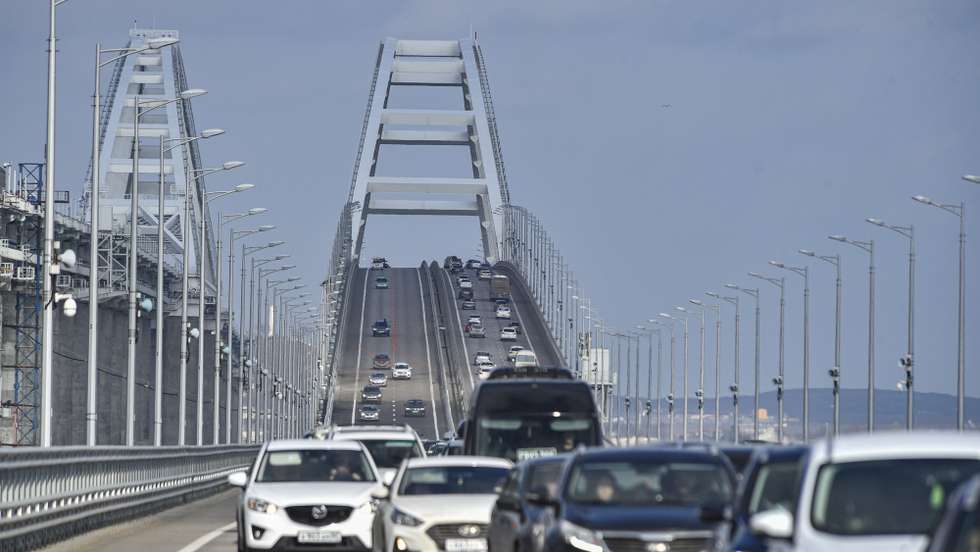 epa10485423 Cars drive across the Crimean bridge in Crimea, 23 February 2023. Automobile traffic resumed on all lanes of the Crimean bridge on 23 February, 39 days ahead of schedule, the press service of Russia's Deputy Prime Minister Marat Khusnullin announced. The motorway of the Crimean Bridge was damaged by an explosion last October. To restore the bridge, some 2,442 tons of metal structures were manufactured, which were delivered from Tyumen, Voronezh and Kurgan. The builders needed to replace four spans on both sides of the bridge, lay two layers of asphalt concrete pavement and install lighting masts.  EPA/STRINGER