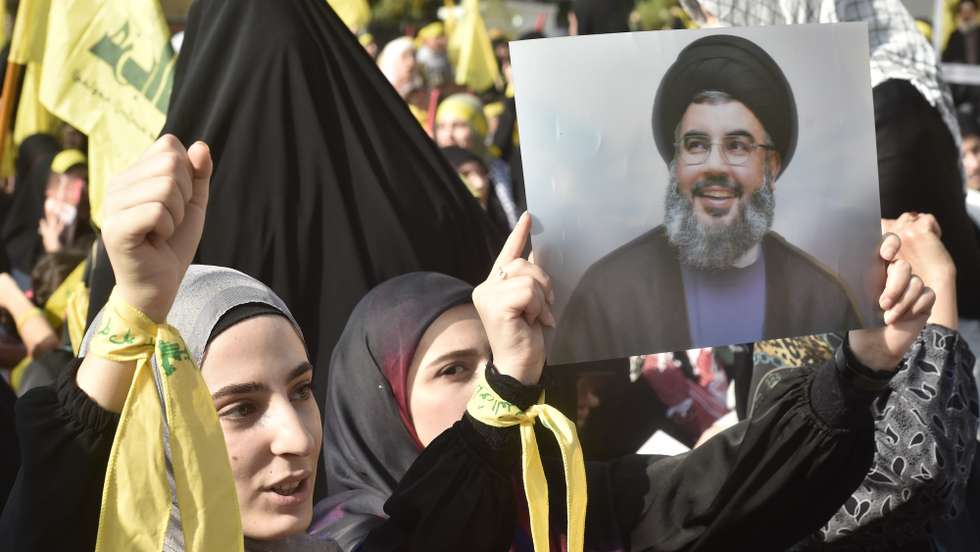 epa10955913 A supporter of Hezbollah holds a photo of the group's leader Hassan Nasrallah as they gather before his speech in the southern suburb of Beirut, Lebanon, 03 November 2023. Hezbollah chief Hassan Nasrallah is expected to give his first speech since escalation of the Israel-Hamas conflict. Tensions remain high at the border between Israel and Lebanon after the Israeli-Palestinian conflict escalated following an unprecedented attack carried out by Hamas militants from Gaza into Israel on 07 October 2023.  EPA/WAEL HAMZEH