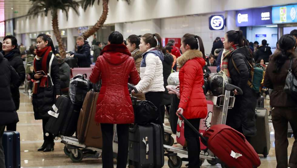 epa08084433 North Korean women stand together at Beijing Capital International Airport in Beijing, China, 21 December 2019. North koreans working in United Nations (UN) Member States are returnig home, as dictated by the UN Security Council Resolution 2397, adopted in 2017, which calls on Member States to repatriate all North Korean nationals earning income in that Member Stateâ€™s jurisdiction.  EPA/YONHAP SOUTH KOREA OUT