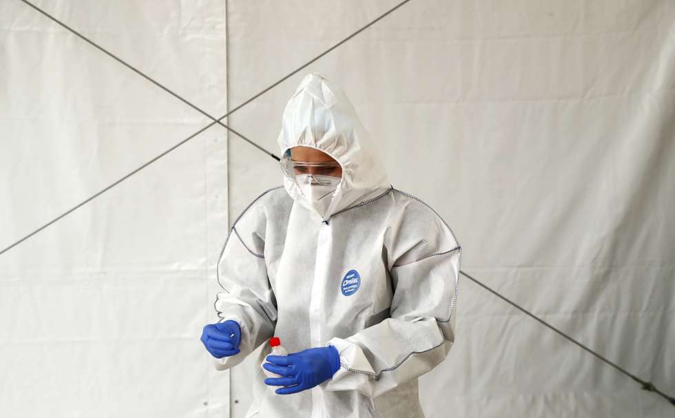 epa08743637 Firefighter takes a nose swab samples at a drive test station for Covid-19 coronavirus in Montpellier, France, 14 October 2020. Montpellier has been declared a city of 'maximum alert circulation' for the Covid19 coronavirus, as cases surged in recent weeks.  EPA/Guillaume Horcajuelo