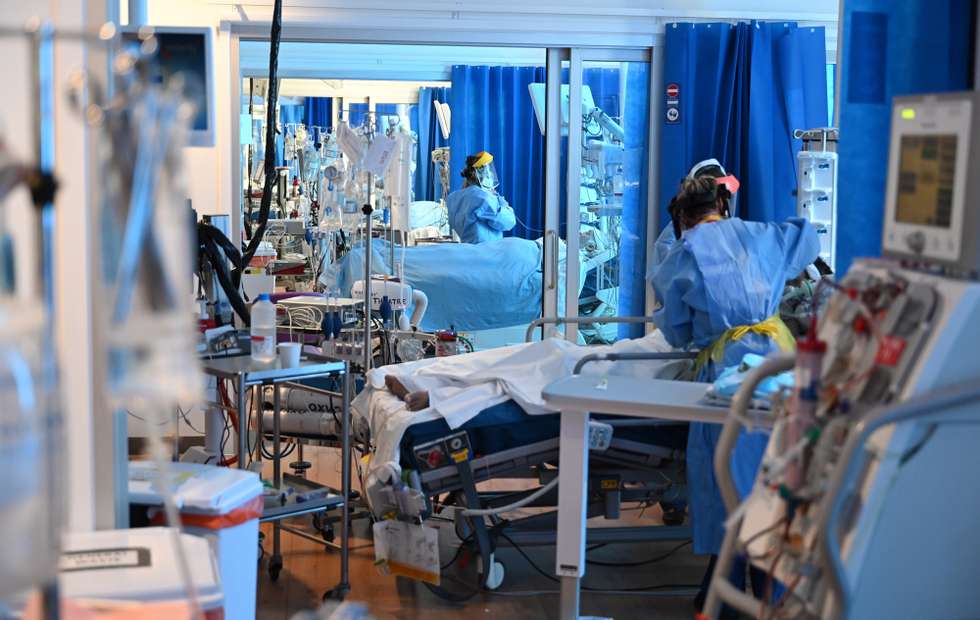 epa08403529 Clinical staff wear Personal Protective Equipment (PPE) as they care for a patent at the Intensive Care unit at Royal Papworth Hospital in Cambridge, Britain, 05 May 2020. NHS staff wear an enhanced level of PPE in higher risk areas such as critical care to minimise the spread of infection between staff and patients. Countries around the world are taking increased measures to stem the widespread of the SARS-CoV-2 coronavirus which causes the Covid-19 disease.  EPA/NEIL HALL / POOL  ATTENTION: This Image is part of a PHOTO SET