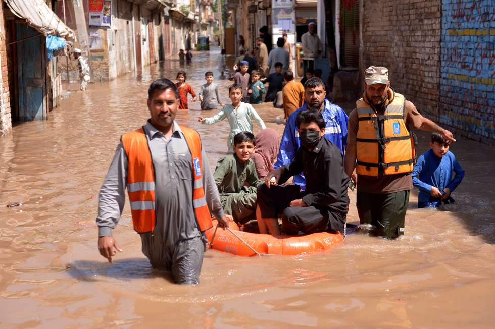 epa12868641 Rescue workers evacuate people from flooded areas after heavy rain in Charsadda district, on the outskirts of Peshawar, Pakistan, 04 April 2026. Dozens of people have been killed and more injured in rain-related incidents across Khyber Pakhtunkhwa province since March 25, as heavy downpours caused roofs and walls to collapse, the Provincial Disaster Management Authority said.  EPA/ARSHAD ARBAB