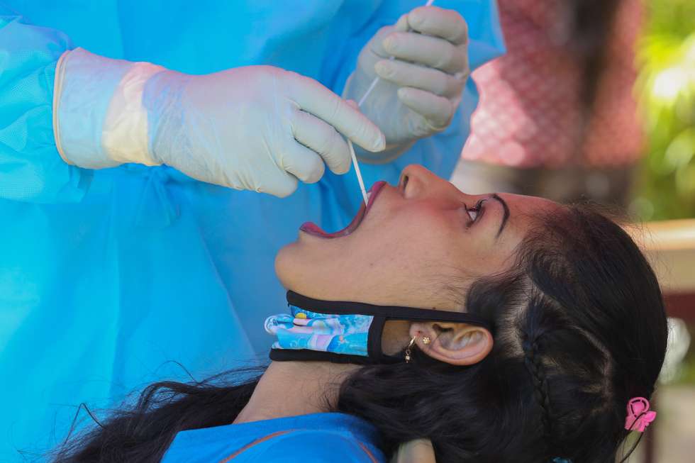 epa09104350 A Sri Lankan woman undergoes a COVID-19 swab test in Colombo, Sri Lanka, 29 March 2021. Sri Lanka is in the midst of a new wave of COVID-19 infections and the number of cases is increasing day by day.  EPA/CHAMILA KARUNARATHNE