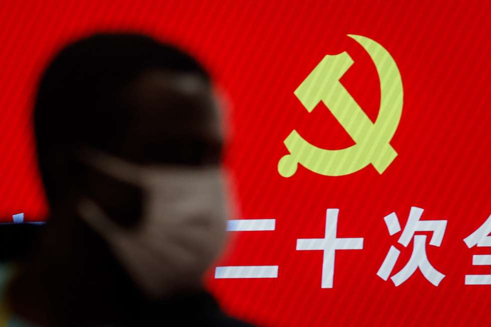 epa10248624 A journalist stands along the emblem of the Communist Party of China during a press conference at the Hotel Nikko New Century in Beijing, China, 17 October 2022. A press conference was held to give a brief on how the Communist Party of China (CPC) will continue to exercise its strict self-governance over the party. The 20th National Congress of the Communist Party of China opened on 16 October where Chinese President Xi Jinping is expected to be granted a third five-year term.  EPA/MARK R. CRISTINO