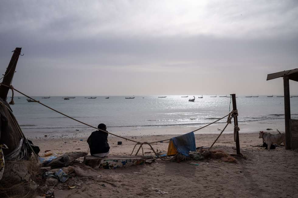 epa11846368 A young man sits on the beach in Bargny, 30 kilometres west of Dakar, Senegal, 17 January 2025 (issued 23 January 2025). In October 2023 from this location, a pirogue with over 100 would-be migrants left Senegal for Spain in search of better opportunities and disappeared forever. 'Nobody (of the more than a hundred who were travelling on the boat) has been recovered,' said local resident Binata Dieng, whose 19-year-old daughter was on board. According to figures from the European Border and Coast Guard Agency (Frontex), more than 87,000 people arrived in Spain via the Atlantic route in 2023 and 2024, coming not only from Senegal but also from countries such as Mauritania and Gambia. In Bargny, the local government estimates that nearly 3,000 people from the settlement have taken this migratory route in the last two years. Bargny symbolises one of the greatest tragedies of emigration and the intersection between environmental deterioration and socio-economic fragility in coastal cities in Senegal.  EPA/JEROME FAVRE