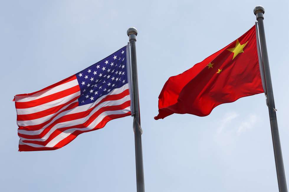 epa12293338 National flags of the United States and China are seen in front of the General Electric Science Park in Beijing, China, 11 August 2025. 12 August marks the deadline for the 90-day extension of the truce about the reciprocal tariffs between the US and China.  EPA/WU HAO
